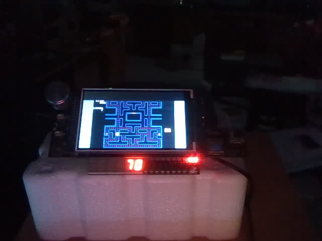 Webcam photo of the DE10-Lite with the shield: the maze on the LCD and 70 on the 7-segment display.