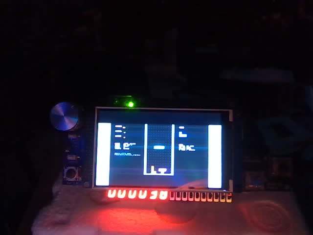 Webcam photo of the DE10-Lite with the shield: the game on the LCD and 000030 on the 7-segment display.